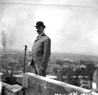 Cass Gilbert, MN State Capitol Architect, standing near the dome at the top of the capitol. May 9, 1901.